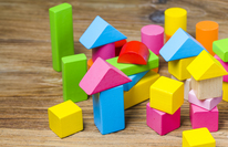 Medium_building-blocks-wooden-background-colorful-wooden-building-blocks